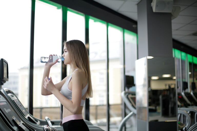 woman drink water in the treadmill
